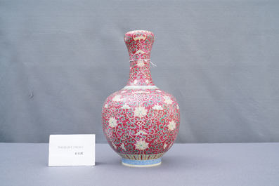 A Chinese famille rose ruby-ground bottle vase, Qianlong mark, 19/20th C.
