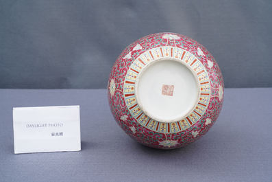 A Chinese famille rose ruby-ground bottle vase, Qianlong mark, 19/20th C.