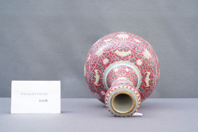 A Chinese famille rose ruby-ground bottle vase, Qianlong mark, 19/20th C.