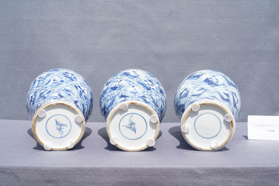 A large Chinese blue and white five-piece garniture with floral and landscape panels, Kangxi