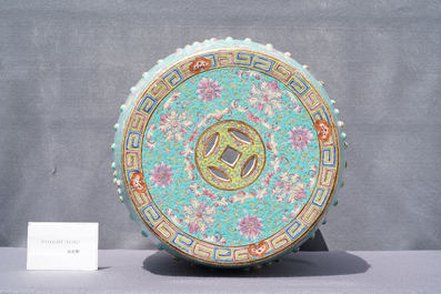 A pair of Chinese turquoise-ground famille rose garden seats, 19th C.