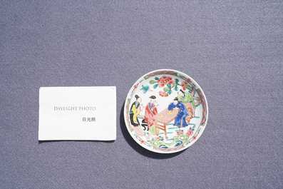 A Chinese famille rose 'tea scene' cup and saucer, Yongzheng/Qianlong
