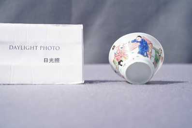 A Chinese famille rose 'tea scene' cup and saucer, Yongzheng/Qianlong