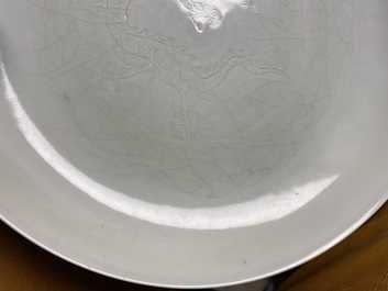 A Chinese monochrome celadon underglaze 'dragon' dish, Qianlong/Jiaqing