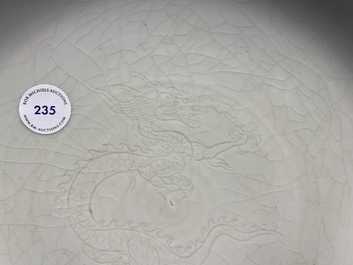 A Chinese monochrome celadon underglaze 'dragon' dish, Qianlong/Jiaqing