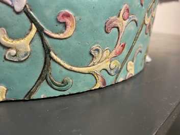 A large Chinese famille rose cylindrical vase with molded lotus scrolls, Jiaqing/Daoguang
