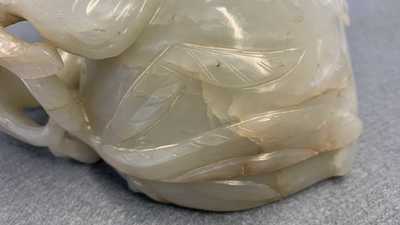 A Chinese mottled celadon and brown jade peach-form brush washer, Qing