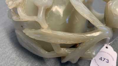 A Chinese mottled celadon and brown jade peach-form brush washer, Qing