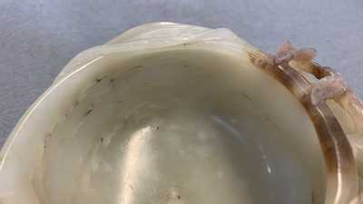 A Chinese mottled celadon and brown jade peach-form brush washer, Qing