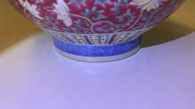 A Chinese famille rose ruby-ground bottle vase, Qianlong mark, 19/20th C.