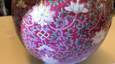 A Chinese famille rose ruby-ground bottle vase, Qianlong mark, 19/20th C.