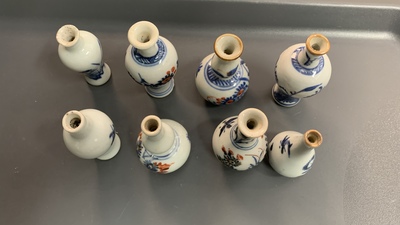 Six Chinese blue and white cups and saucers and eleven miniature vases, Kangxi