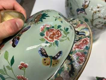 A pair of large Chinese Canton famille rose celadon-ground vases and covers, 19th C.