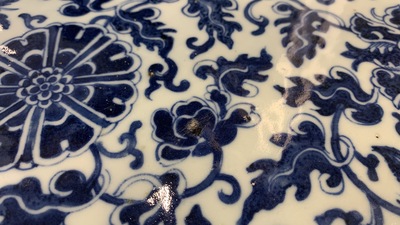 A large Chinese round blue and white plaque with floral design, 19th C.