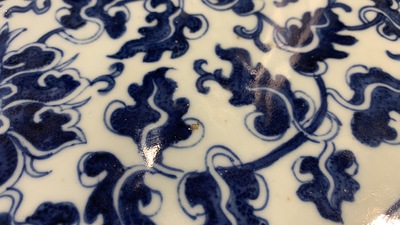 A large Chinese round blue and white plaque with floral design, 19th C.