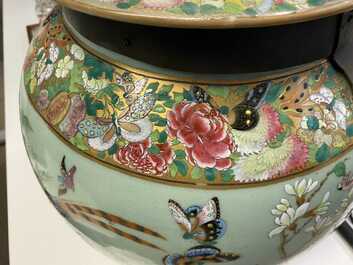 A pair of large Chinese Canton famille rose celadon-ground vases and covers, 19th C.