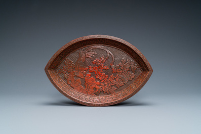 A Chinese pointed oval red cinnabar lacquer 'peacock' tray, three-character mark, Qianlong