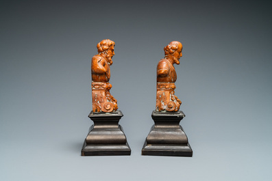 A pair of boxwood busts of a saint on an ebony veneer base, 17th C.
