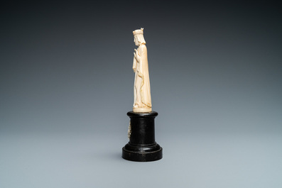 An ivory figure of a female saint holding a book, 19th C.
