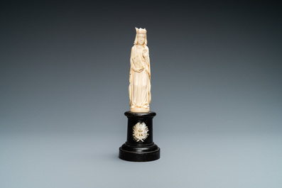 An ivory figure of a female saint holding a book, 19th C.