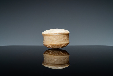 An ivory box and cover with a boy sitting by a water well, 18th C.
