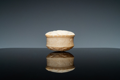 An ivory box and cover with a boy sitting by a water well, 18th C.