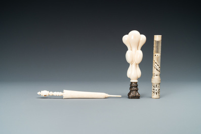 An ivory 'Stanhope' miniature umbrella with microscopical views on Paris, a seal stamp and a bone needle case, 19th C.
