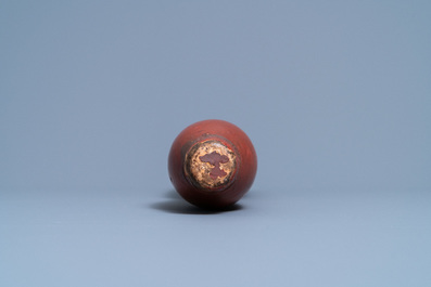 A Chinese bronze gong set in a carved wooden stand, 19th C.