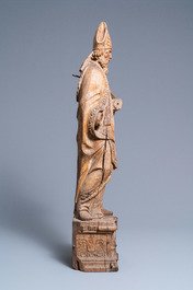 A large oak figure of a bishop on a reliquary base, Flanders, 18th C.