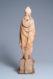 A large oak figure of a bishop on a reliquary base, Flanders, 18th C.