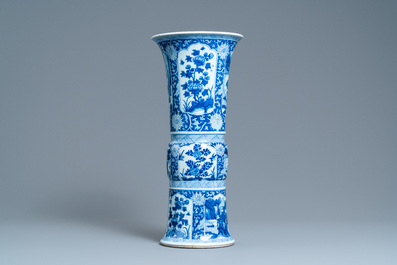 A Chinese blue and white 'gu' vase with floral and lanscape panels, Kangxi