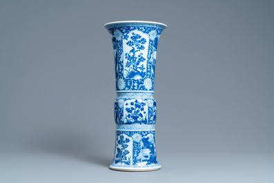 A Chinese blue and white 'gu' vase with floral and lanscape panels, Kangxi