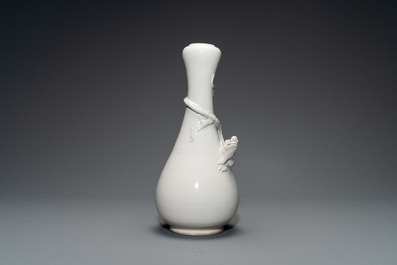A Chinese Dehua blanc de Chine vase with applied dragon, Kangxi/Yongzheng