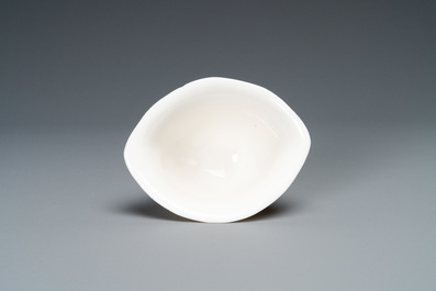 A Chinese Dehua blanc de Chine tripod wine cup with inscription, Kangxi