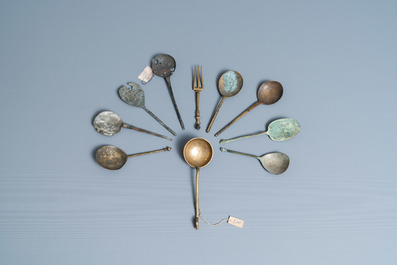 Nine brass spoons and a small fork, 15/16th C.