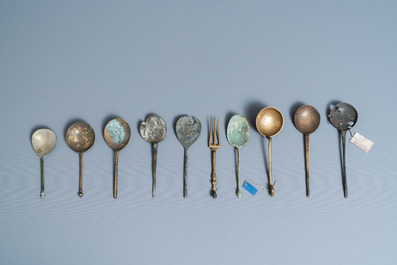 Nine brass spoons and a small fork, 15/16th C.