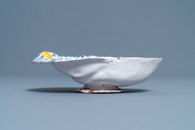 A polychrome faience oval footed bowl with a bathing woman, France, 17th C.