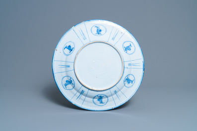 A Dutch Delft blue and white chinoiserie dish with figurative medallions on the back, late 17th C.