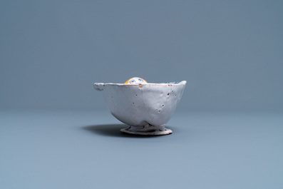A polychrome faience oval footed bowl with a bathing woman, France, 17th C.