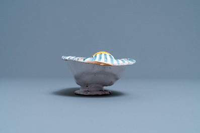 A polychrome faience oval footed bowl with a bathing woman, France, 17th C.