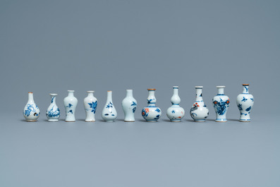 Six Chinese blue and white cups and saucers and eleven miniature vases, Kangxi