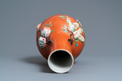 A Chinese famille rose 'sanduo' vase with applied design on a coral red ground, 19th C.