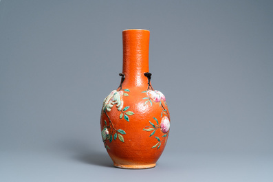 A Chinese famille rose 'sanduo' vase with applied design on a coral red ground, 19th C.