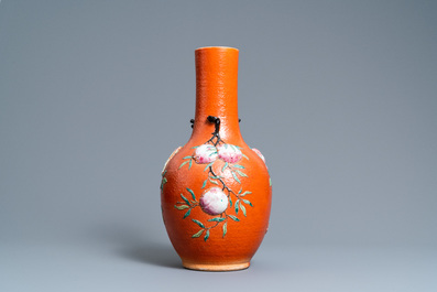 A Chinese famille rose 'sanduo' vase with applied design on a coral red ground, 19th C.