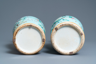 A pair of Chinese famille rose turquoise-ground vases with butterfly handles, 19th C.