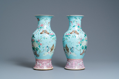 A pair of Chinese famille rose turquoise-ground vases with butterfly handles, 19th C.