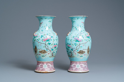 A pair of Chinese famille rose turquoise-ground vases with butterfly handles, 19th C.