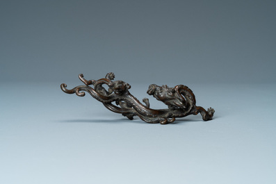 A rare Chinese bronze 'dragon' brush rest, Yuan/Ming