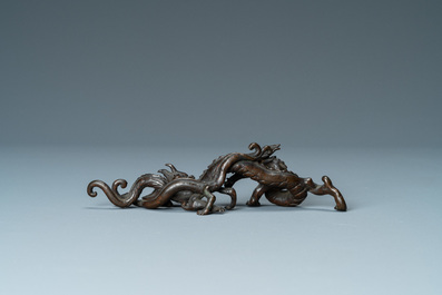 A rare Chinese bronze 'dragon' brush rest, Yuan/Ming