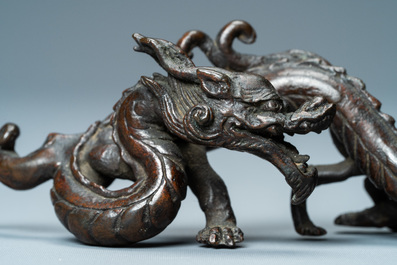 A rare Chinese bronze 'dragon' brush rest, Yuan/Ming